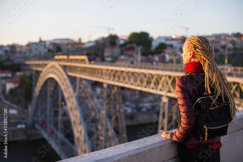 Woman on the viewing platform opposite the Dom Luis I bridge across the Douro river, Porto, Portugal.
