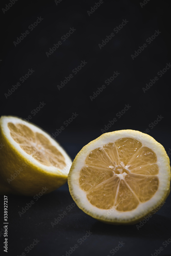 Two halfs of a lemon on black background with copy space Two halfs of a lemon on black background with copy space