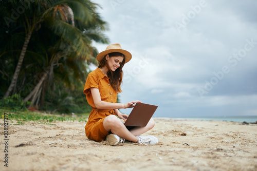 Woman on nature beach island travel laptop communication