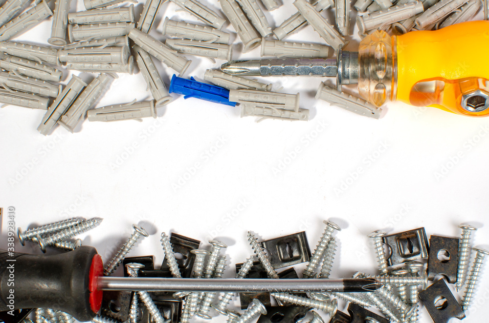 Fototapeta premium metal fasteners uniform background close-up and tool