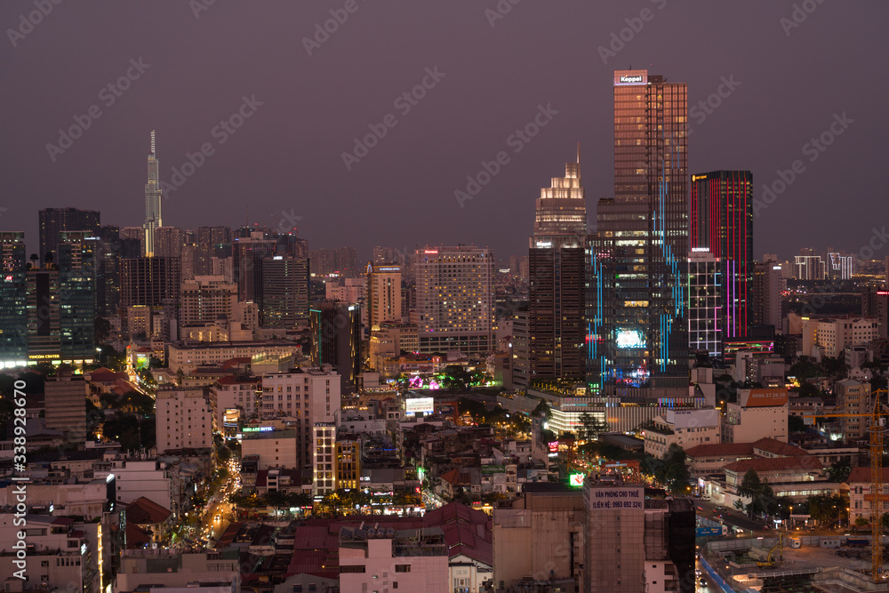 Naklejka premium Sunset reflects off skyscrappers in downtown Ho Chi Minh City.