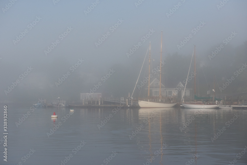 Boats Anchored In Foggy Harbor