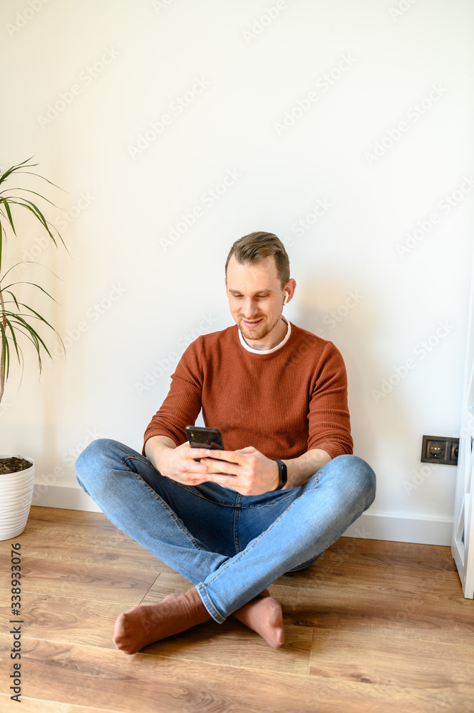 Young guy chatting on the phone at home Young guy chatting on the phone at home