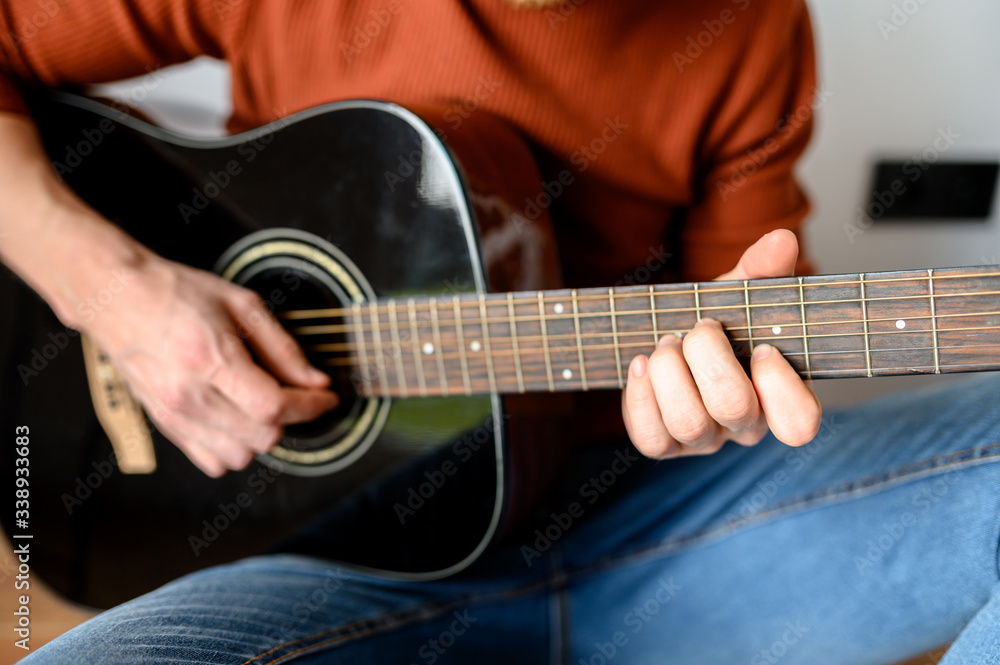 Close-up of an acoustic guitar in hands