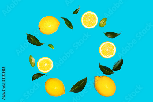 Creative layout made of flying yellow lemon with leaves on green mint color background.