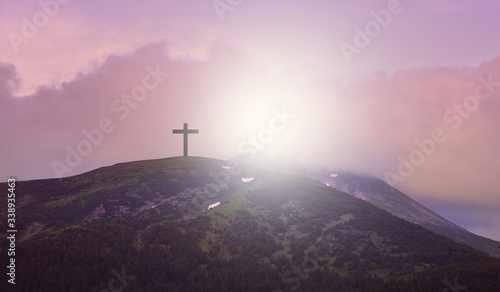 Cross. Calvary, Crucifixion. Resurrection.  Sign of the cross against the sky. The cross of Jesus on the background of sunrise of the sun. The resurrection of Jesus. Easter