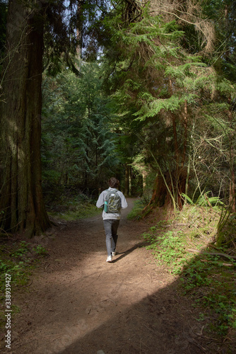 Teenager walking on the forest with a backpack and a water bottle © tomifj94