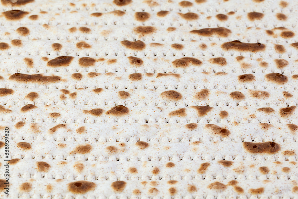 Matzah. Jewish traditional Passover bread. Pesach celebration symbol. With some free space for your text or sign . Close-up.