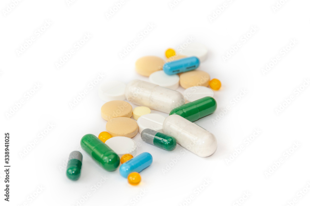 Heap of various medicine pills on white background.