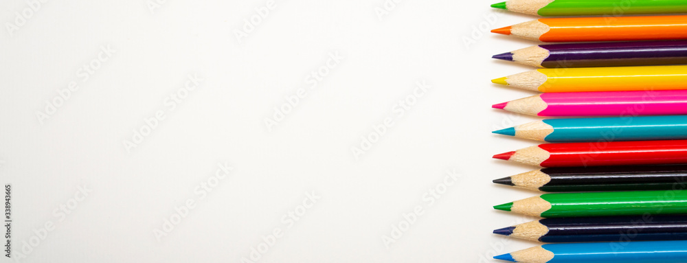 Multi-colored pencils on a white background with copy space. Multi-colored pencils on a white background with copy space.