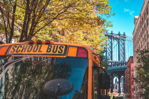 School bus in Brooklyn with a Manhattan bridge in the background.