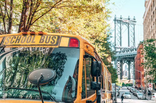 School bus in Brooklyn with a Manhattan bridge in the background.