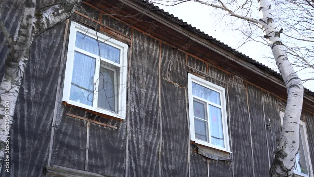 Old wooden, two-story, apartment building. Cloudy day, winter. Russia, Siberia. Khanty-Mansi Autonomous Okrug-Yugra Old wooden, two-story, apartment building. Cloudy day, winter. Russia, Siberia. Khanty-Mansi Autonomous Okrug-Yugra