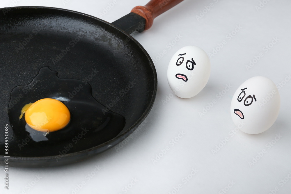 concept of a fear. frightened eggs are looking at the pan Stock Photo