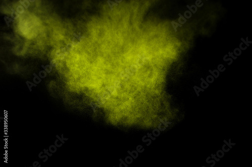 Light green powder explosion on black background. Colored powder cloud. Colorful dust explode. Paint Holi.