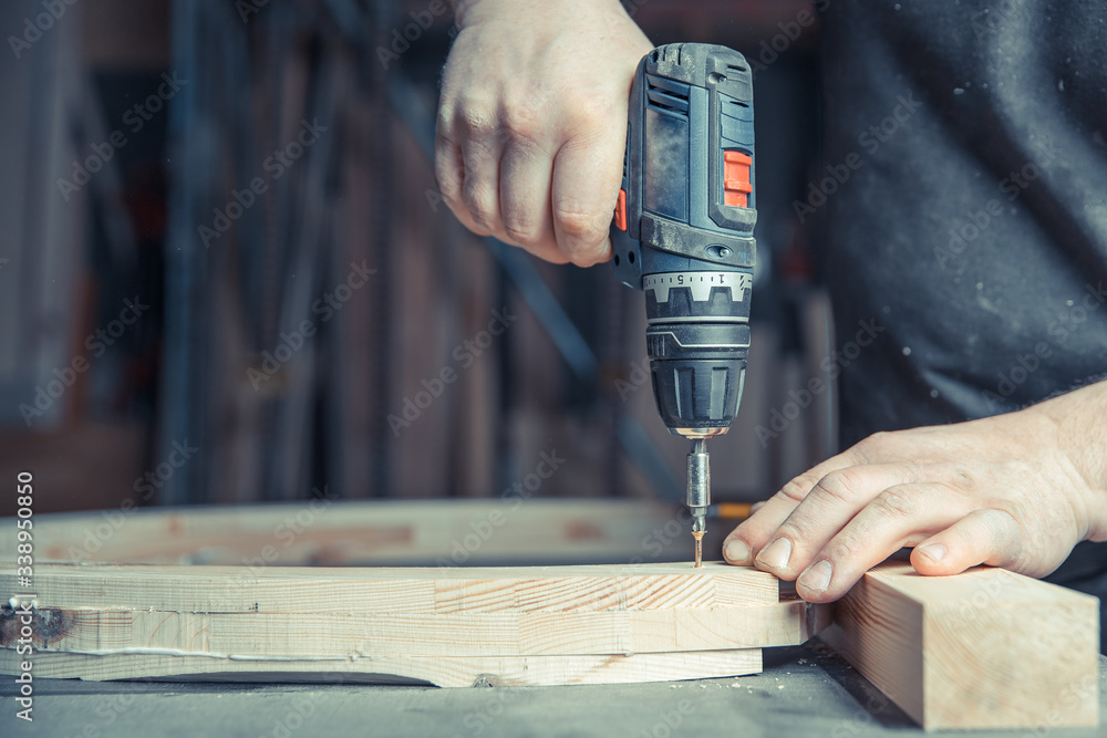 screwing wooden furniture in a joinery using an electric drill bit