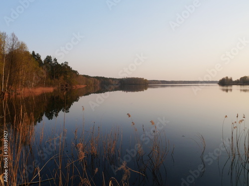 Lake at sunset  on a background of trees. Reflection of nature in the lake. Diamond Lake Kiev  Ukraine.
