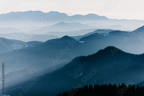 Fototapeta Naklejka Na Ścianę i Meble -  Blue misty mysterious mountains in the distance at the sunset.