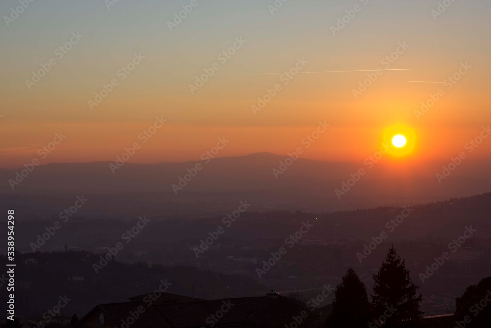 Sunset through umbrian hills