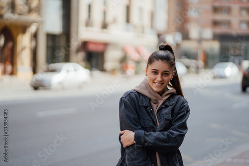 Portrait the young beautiful girl on the background of spring street © teksomolika