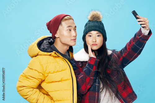 Man and woman of Asian appearance communication fashion lifestyle photo on the phone