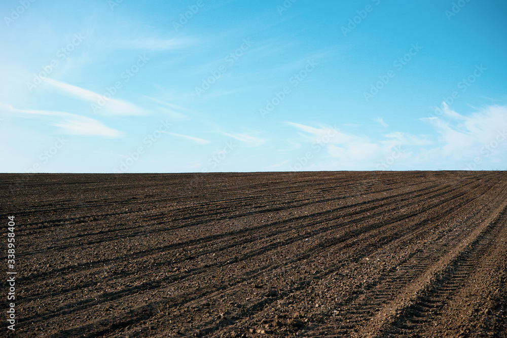 Plowed soil. Agricultural rural background. Plowed field in early spring.