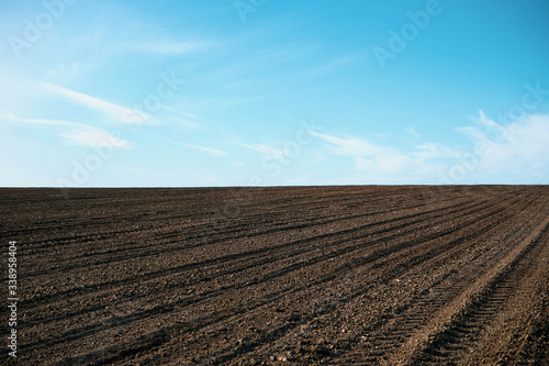 Plowed soil. Agricultural rural background. Plowed field in early spring.