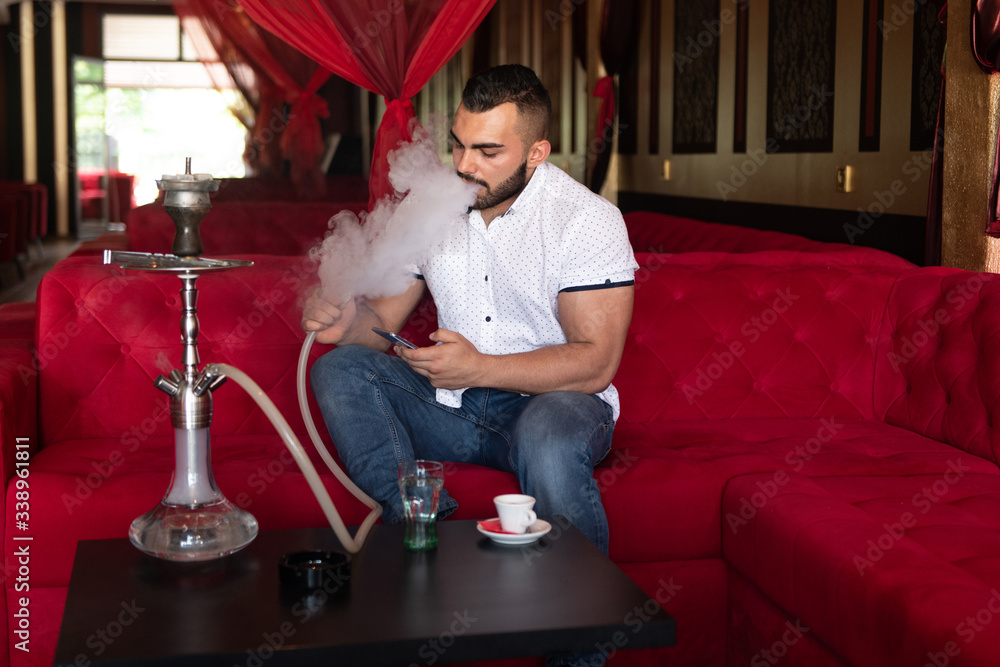 Man Smoking Shisha At Arabic Restaurant