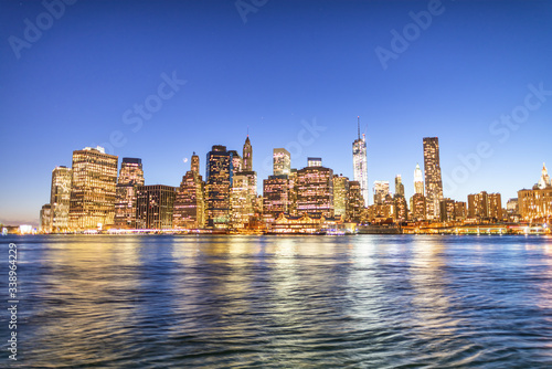 New York City night lights. Lower Manhattan skyline from Brooklyn Bridge Park promenade - USA