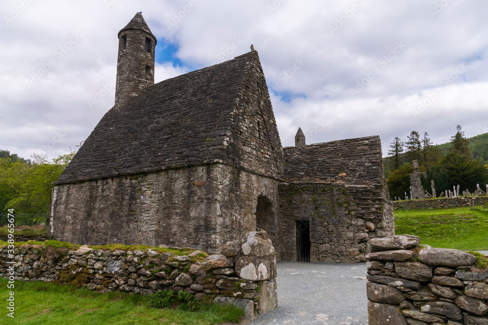 Monastic cemetery of Glendalough, Ireland. Famous ancient monastery in the wicklow mountains with a beautiful graveyard from the 11th century Monastic cemetery of Glendalough, Ireland. Famous ancient monastery in the wicklow mountains with a beautiful graveyard from the 11th century