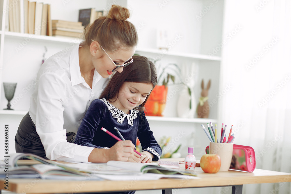 Tutor with pupil. Little girl studying. Private lesson. Tutor with pupil. Little girl studying. Private lesson.