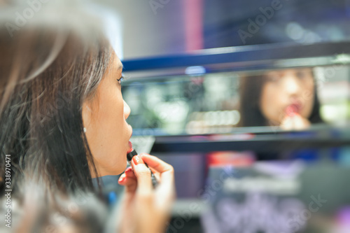Asian girl doing makeup in a beauty shop