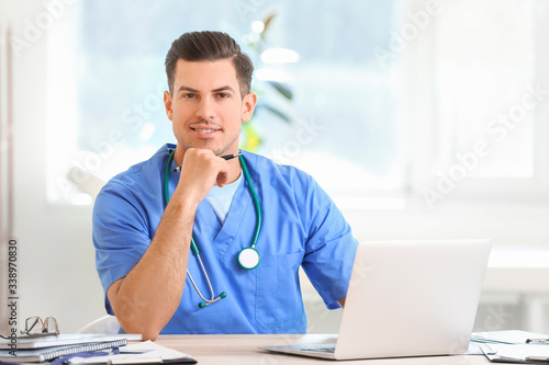 Young male doctor working i...