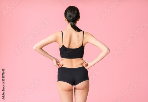 Young woman on color background. Weight loss concept © Pixel-Shot