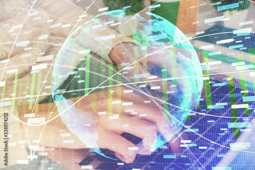 Double exposure of woman hands typing on computer and business theme hologram drawing. Success concept.