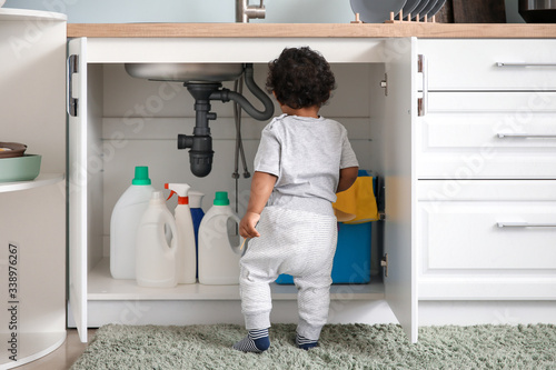 Bild auf Leinwand Little African-American baby playing with detergents at home
