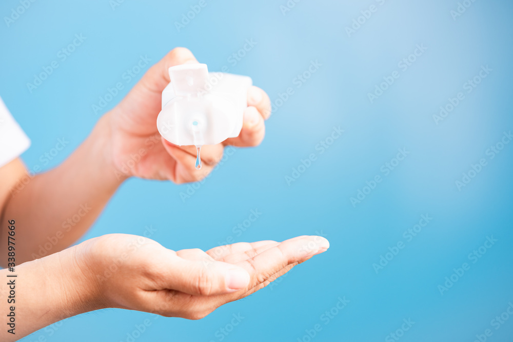 young woman applying drop dispenser sanitizer alcohol gel on hand young woman applying drop dispenser sanitizer alcohol gel on hand