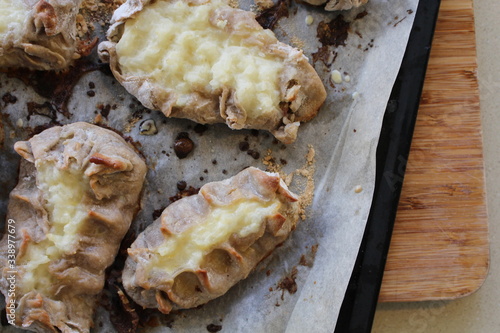 Cooked Karelian pies - Pirakka on a baking sheet. Dish of national cuisine - piirakka. Close-up. photo