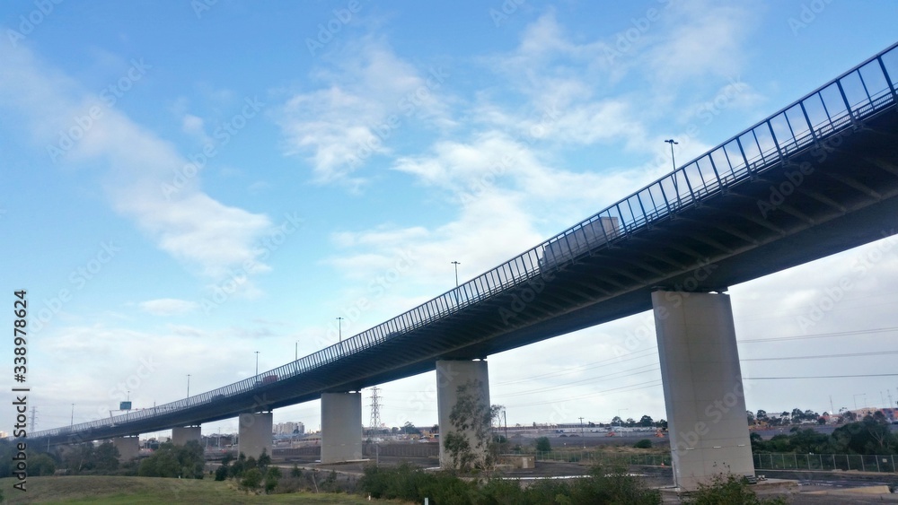 Low Angle View Of Bridge Against Blue Sky