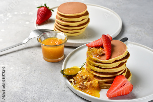 pancake with orange jam, nuts and fresh strawberries. Breakfast food in the morning. pancake recipe. selective focus and copy space. home cooking recipe
