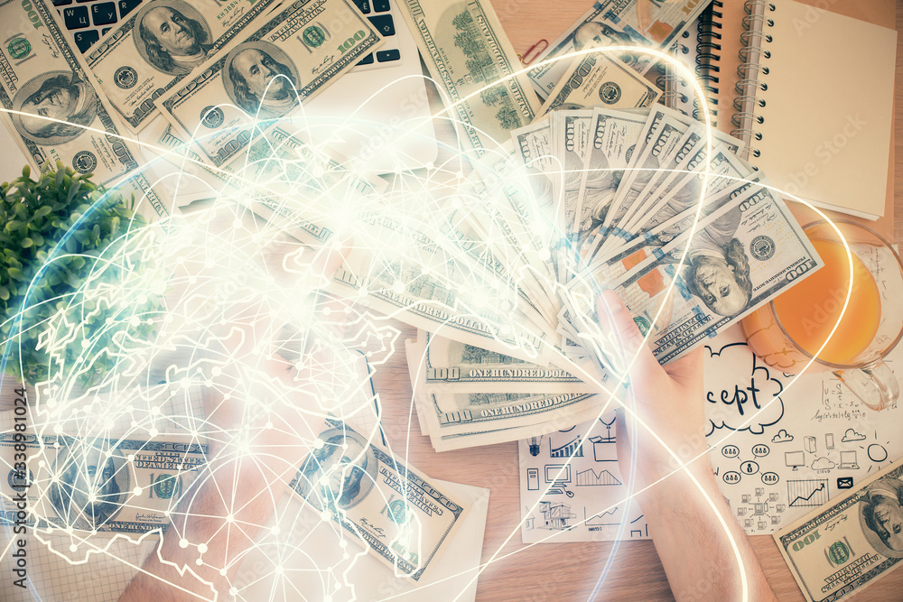 Multi exposure of financial theme drawing hologram and USA dollars bills and man hands. Business concept. Multi exposure of financial theme drawing hologram and USA dollars bills and man hands. Business concept.
