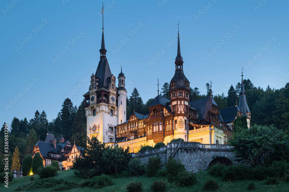 Peles Castle, famous residence of King Charles I in Sinaia, Romania. Summer landscape at dawn of royal palace and park.