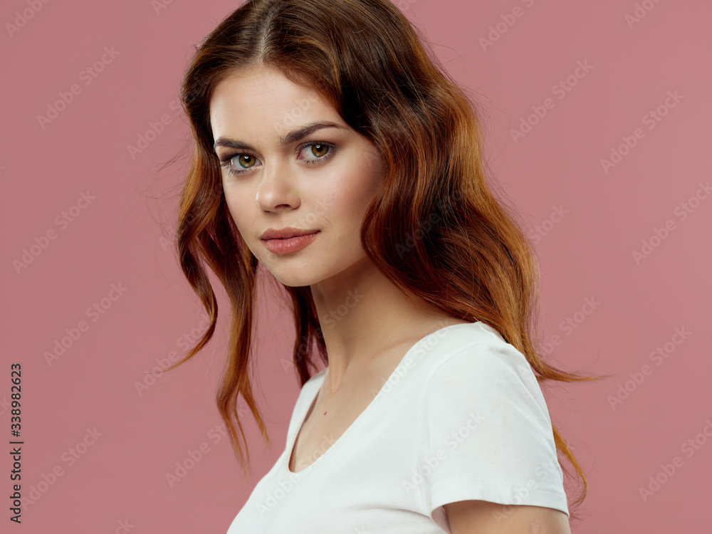 Beautiful woman white t-shirt studio makeup charm pink background model
