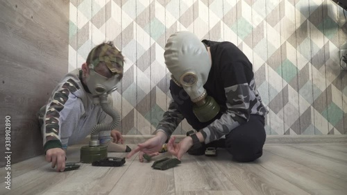 Children in gas mask from viruses play with toys