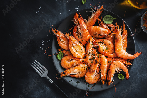 Fried shrimps with spices on plate photo