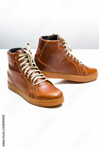 Pair of New Leather Tan Motorcyclist Boots Against White Background