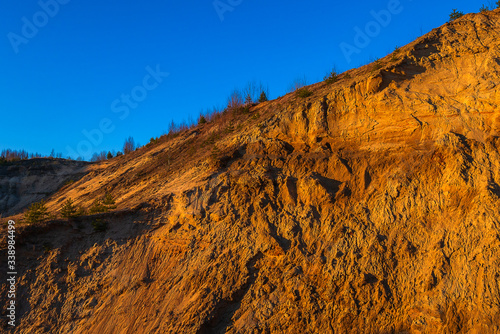 Sandy mountain against the blue cloudless sky.