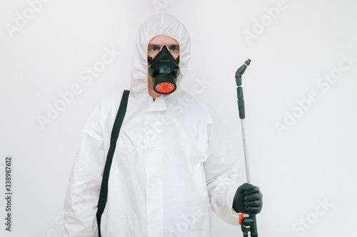 Virologist is weaing in protective clothe during coronavirus pandemic, portrait. Suit, respirator, gloves and glasses on white background in clinic or hospital