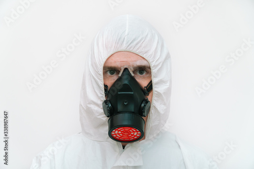 Portrait of a doctor in black mask and protective coverall © Natallia