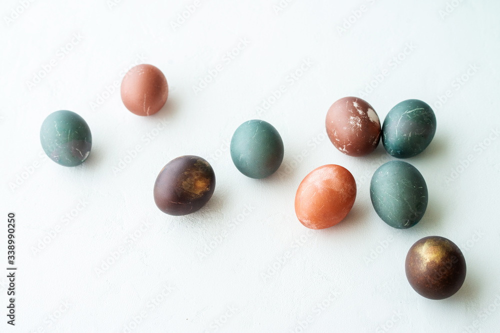 painted eggs on white stone   backround,. Happy easter concept. Natural colorful egg, pastel and natural color.